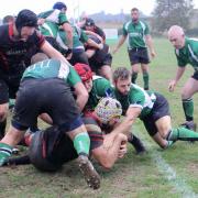 Phoenix (black and red) try scorer Callum Brodie drives for the try line in the 13-5 win against Faringdon on Saturday.