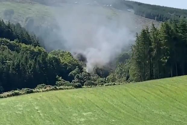 For use in UK, Ireland or Benelux countries onlyScreen grab from BBCScotland showing smoke billowing from the train on the track in the countryside near Stonehaven, Aberdeenshire. Emergency services are at the scene after a train derailed in Aberdeenshi