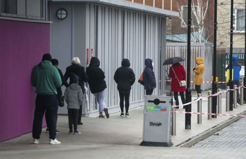People queue at The Centre in Slough, Berkshire, after a rapid testing hub was opened for local residents during Englands third national lockdown to curb the spread of coronavirus (PA)