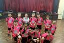 Young children in pink Confidence Through Football kits.