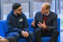 The Prince of Wales (right) speaks with support worker Faizaan Hamid during his visit to Together as One