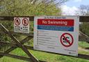 No Swimming warning sign on the Jubilee Flood Alleviation Channel