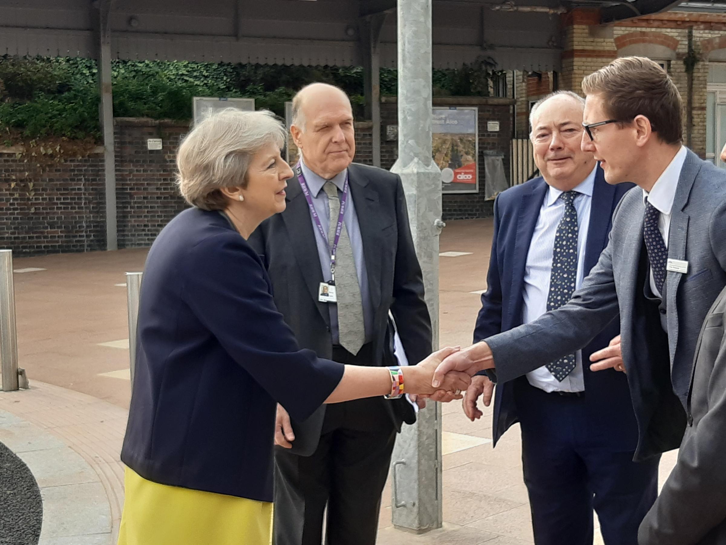 Theresa May shaking hands with Tom Pierpoint, businesses development director of GWR