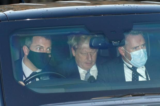 Slough Observer: Prime Minister Boris Johnson (centre) leaves the Houses of Parliament in Westminster, London, as public anger continues to grow (PA)