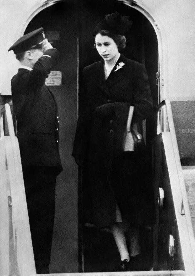 Slough Observer: File photo dated 07/02/52 of Queen Elizabeth II setting foot on British soil for the first time since her accession as she landed at London Airport after her day and night flight from Kenya following the death of her father, King George VI. (PA)