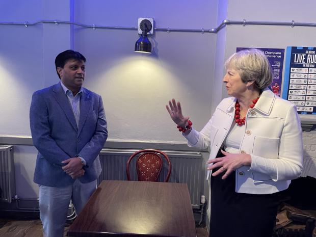 Slough Observer: Ashwin Roda explaining his plans for the pub to MP Theresa May.  Photo: Laura Scardarella