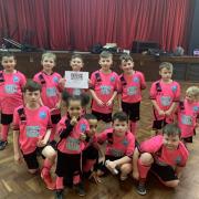 Young children in pink Confidence Through Football kits.