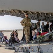 British citizens and dual nationals residing in Afghanistan getting on a RAF plane before being relocated to the UK (PA)