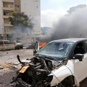 Cars are on fire after they were hit by rockets from the Gaza Strip