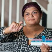 Sue Dhillon holding the cannabis oil that she takes in pill form that she gets from a friend. See SWNS copy SWTPdrug: A mum who was given weeks to live after she shunned chemotherapy has baffled doctors by treating her cancer -- with illegal super