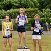 Imogen Wilson, centre, of Maidenhead Athletics Club tops the podium after victory in the 300m in the Berkshire Counties Schools Championships.
