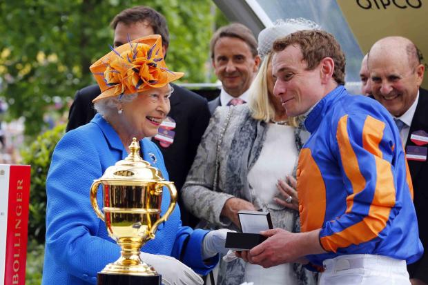 The Queen and jockey Ryan Moore share a joke after Order of St George won the Gold Cup. Pictures: Sue Orpwood.