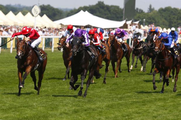 Le Brivido (red) storms to victory in the Jersey Stakes. All pictures by Sue Orpwood.