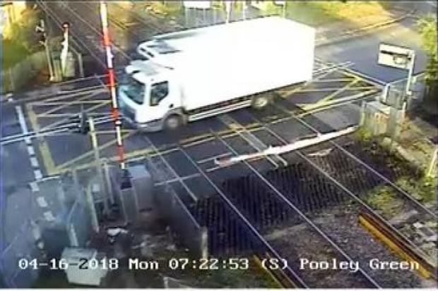 Collision at Pooley Green level crossing in Egham causes travel delays to trains and buses - PICTURED: Network Rail camera footage of the collision