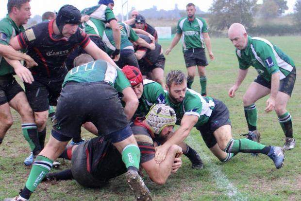 Phoenix (black and red) try scorer Callum Brodie drives for the try line in the 13-5 win against Faringdon on Saturday.